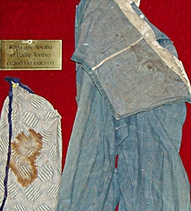 Father Toribio's bloodstained clothing, with visible dark stains