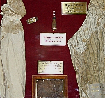 Display case with clothing, blood vial and scapular